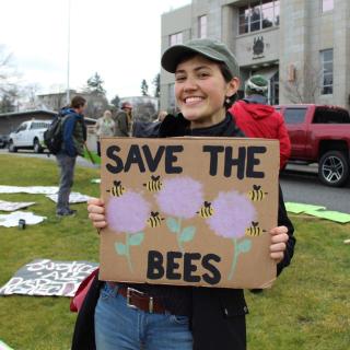 Emma Simard Provencal holding a Save the Bees sign