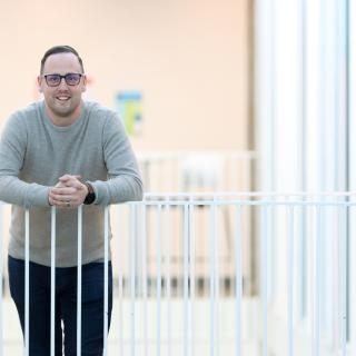 Kyle Duncan leans against a white railing.