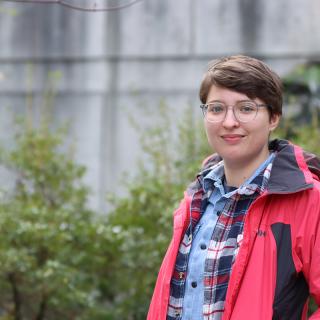 Misha Zvekic stands in a garden at VIU's Nanaimo campus.