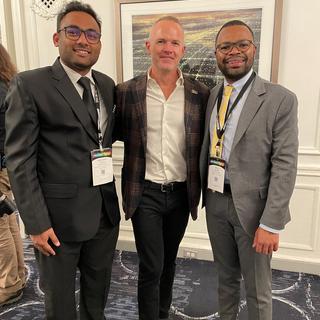 Ashutosh Mishra smiles with other attendees at the Reaching Out MBA (ROMBA) 2SLGBTQ+ conference.