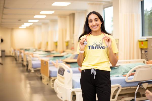 Ashley Sandhu, a Wellness Promoter, in the nursing lab, where she is a student