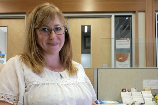 Amanda Rozenboom sitting at her work desk and smiling at the camera