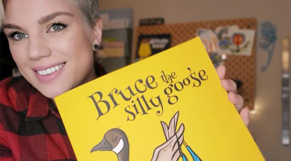 VIU alum Amy Pye holding her new children's book
