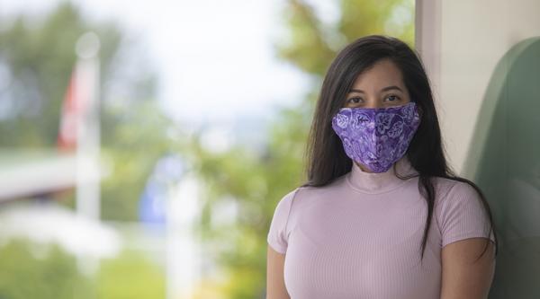 Student sitting wearing a mask