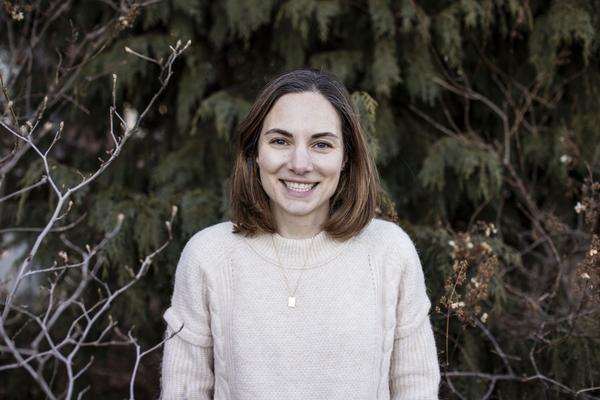 Kimberly Coleman, a woman is standing in front of trees