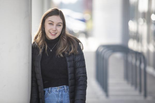 Student posing next to the Health and Science Centre