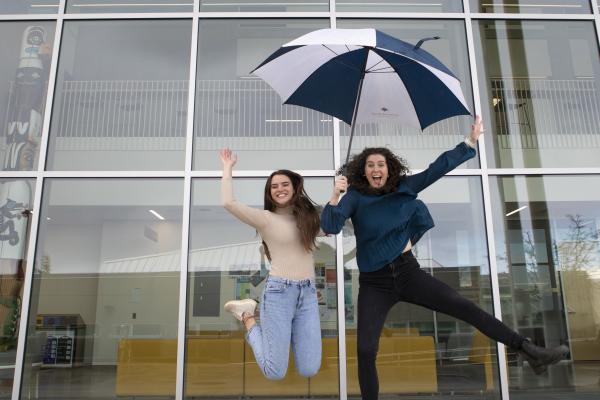 Kayla and Victoria jump in the air