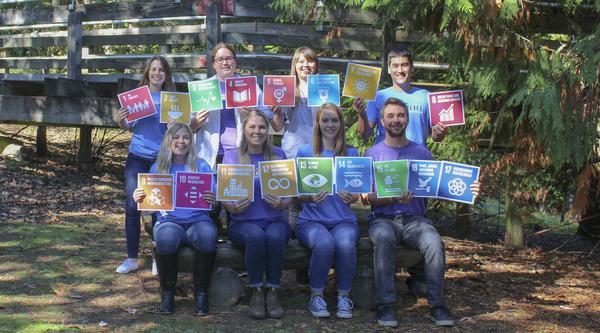 Members of MABRRI hold sustainable Development Goal icons.