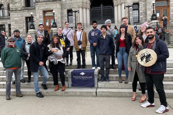 group shot of VIU students and staff standing in front of the Legislature