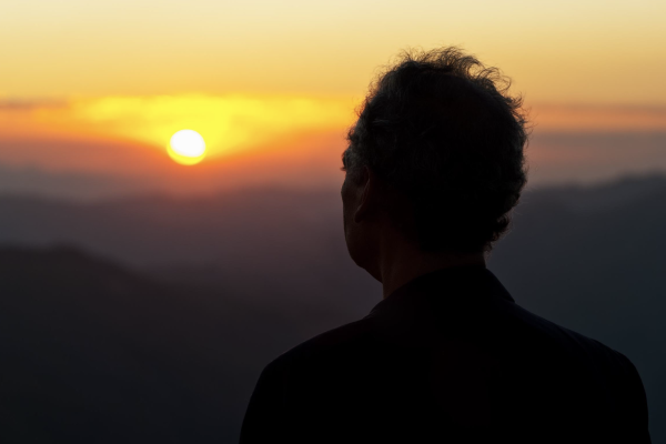 silhouette of a man watching the sunset