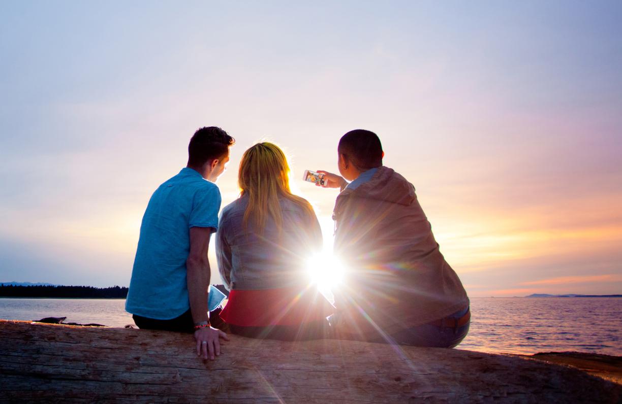 Three students backlit by the sun