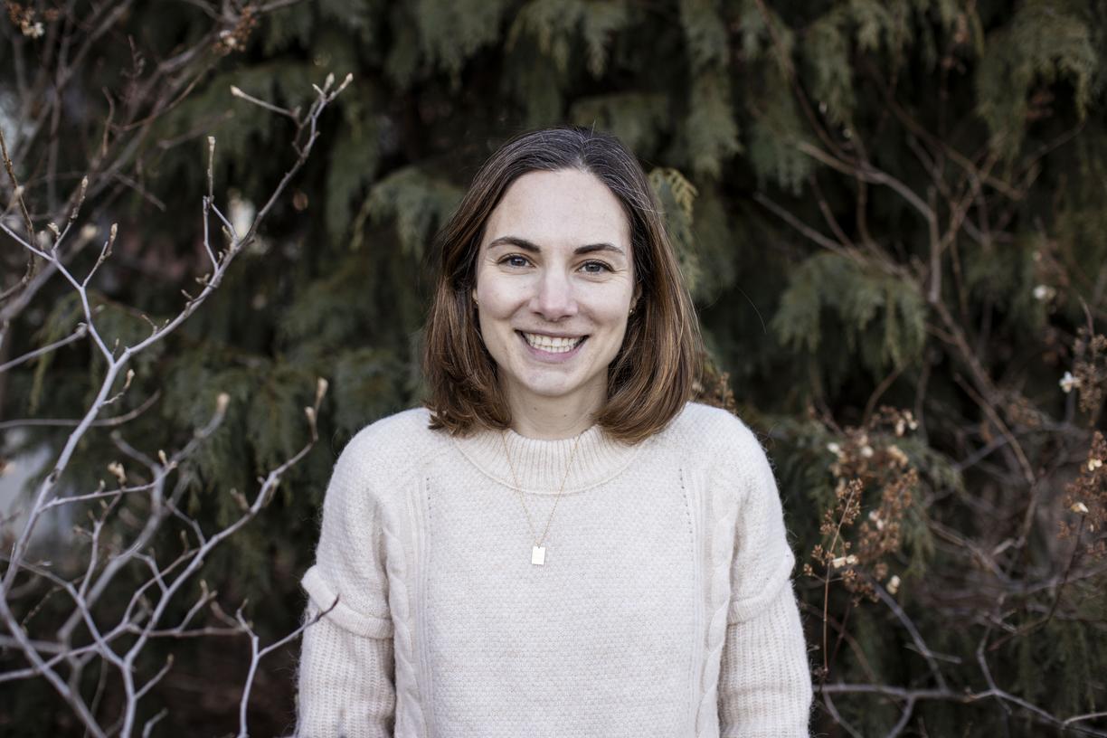 Kimberly Coleman, a woman is standing in front of trees