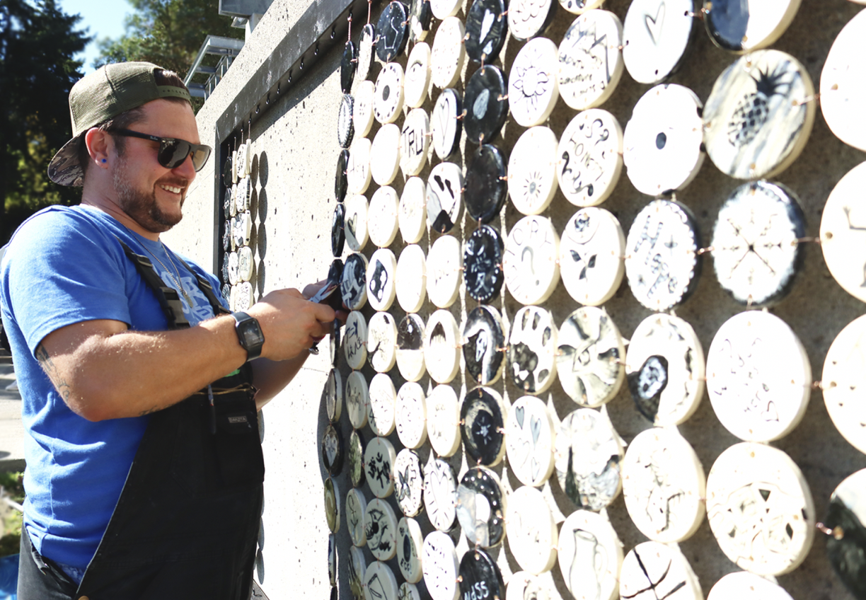 Joe Lyons in front of the mural project