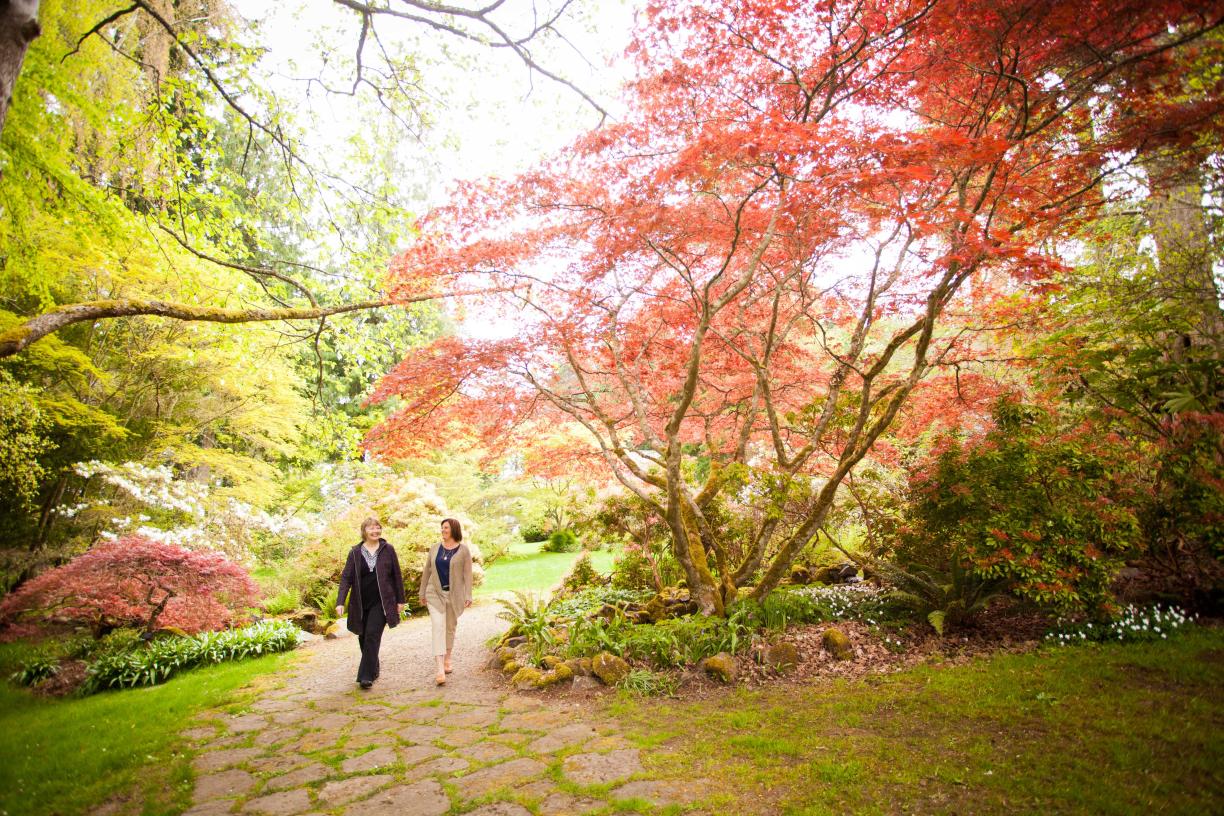 Two women walking a trail at Milner Gardens