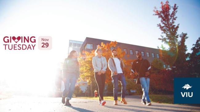 Students walk away from the Health and Science Centre, words Giving Tuesday Nov 29 on side