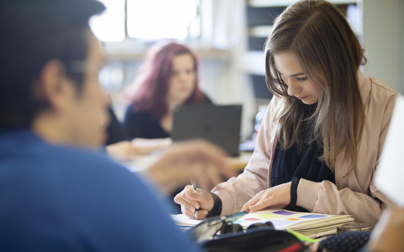 female student writing in notebook