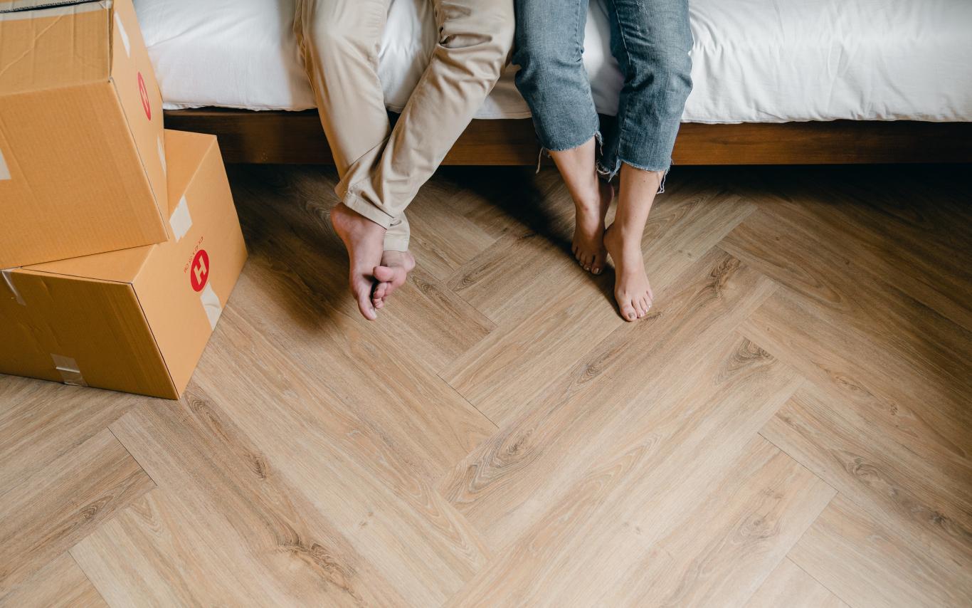 people sitting on a bed with boxes around them